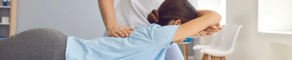 Chiropractor Demonstrating Neuropathy and Nerve Discomfort Treatments to a Patient in Clinic