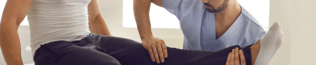 Athlete Discussing Sports Injury Treatment with a Chiropractor in a Clinic