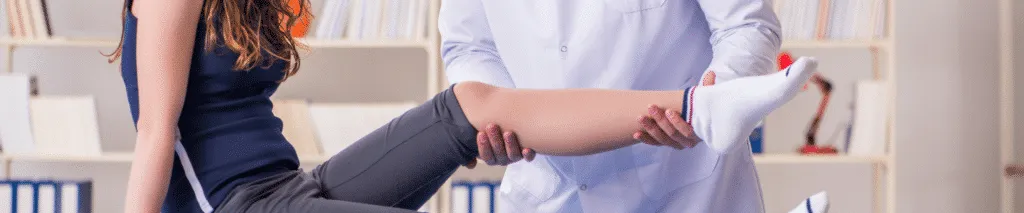 Chiropractor Discussing Non-Medical Treatment Options with Patient for a Minor Injury in Clinic