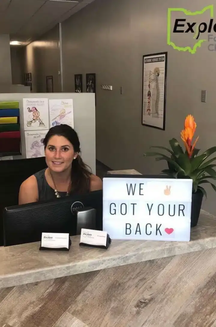 Chiropractor standing in front of the reception desk at Explore Family Chiropractic clinic